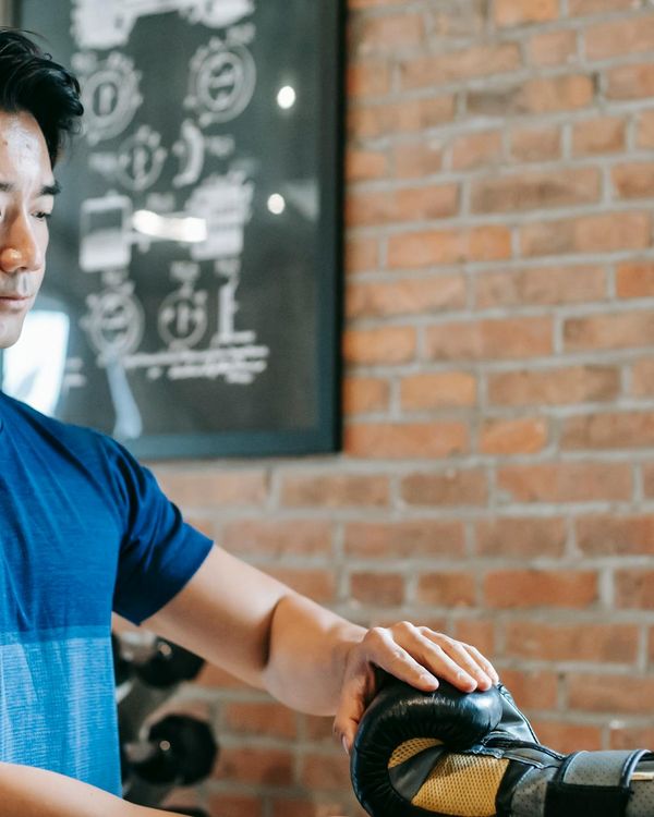 A fitness instructor provides guidance to a client during a workout.